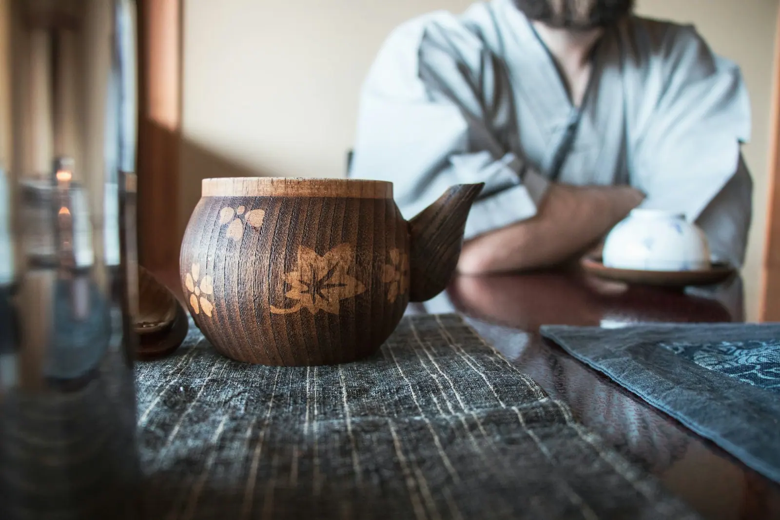 A pot of herbal tea steaming on wood