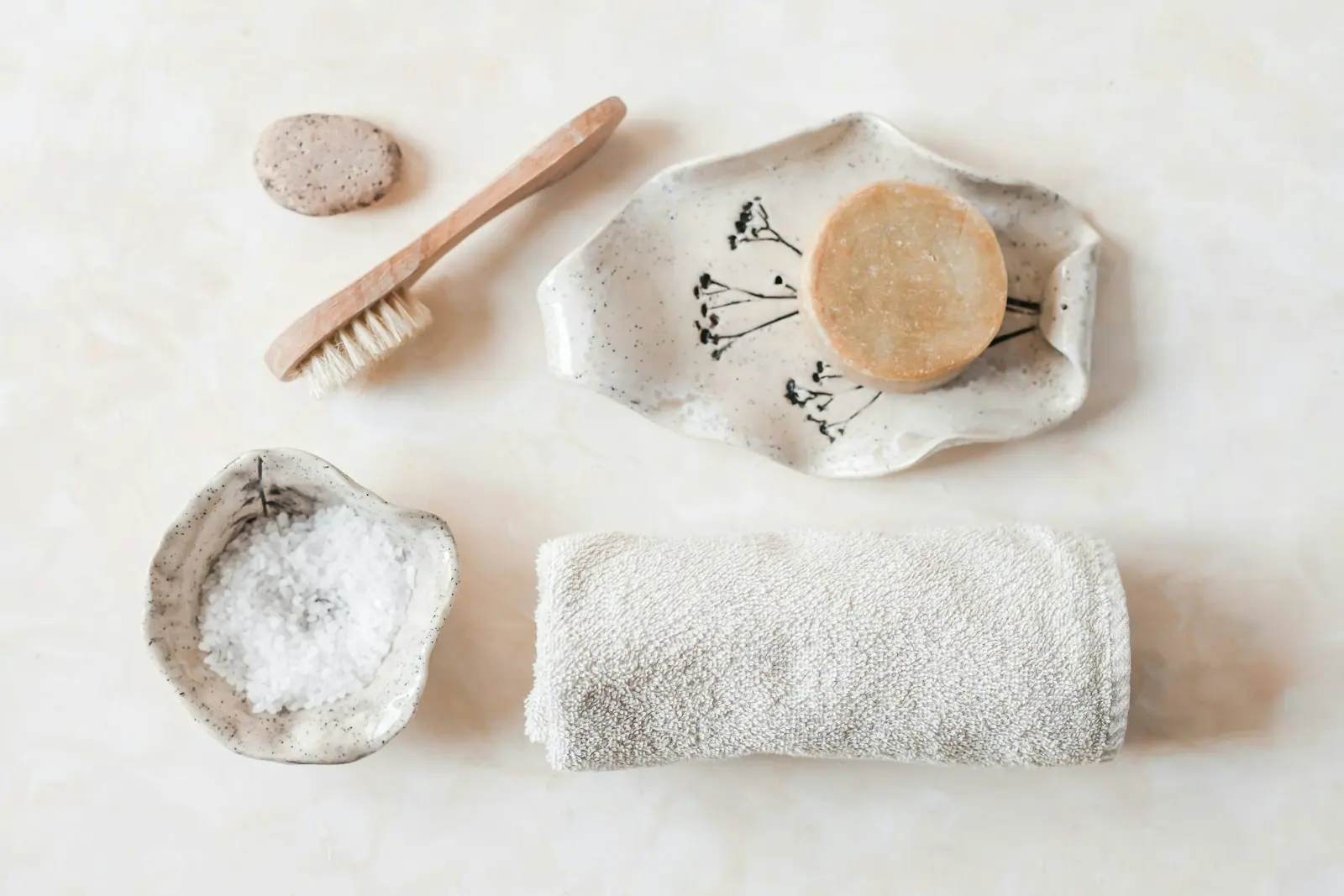A spa still life of towel, flower and stone