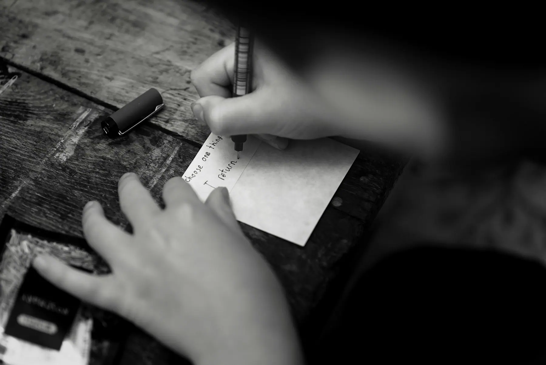 A practitioner's notebook and pen on a wooden desk