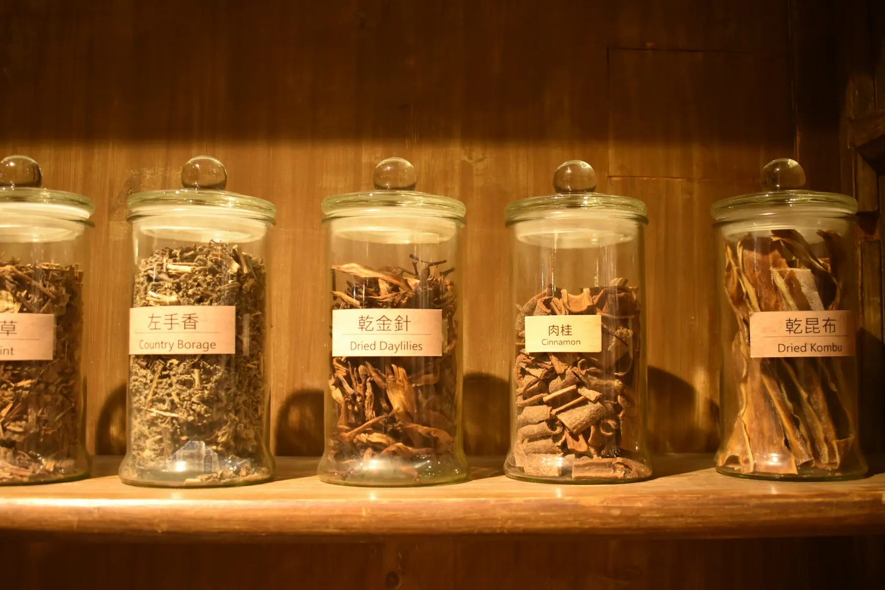 Herbal tea and dried botanicals arranged on a wooden tray